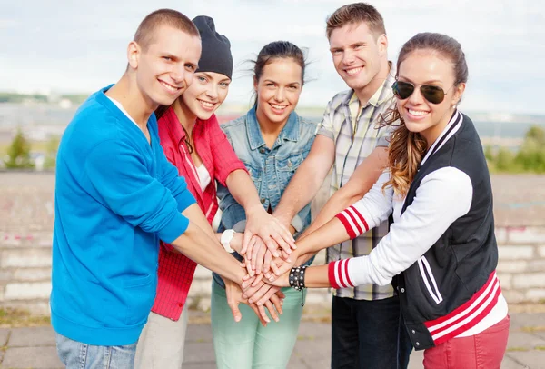 Teenageři ruce na horní části navzájem venku — Stock fotografie