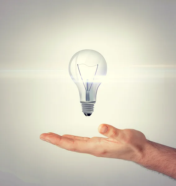 Man hand with light bulb — Stock Photo, Image