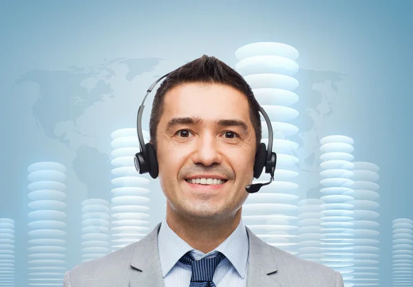 Sonriente hombre de negocios en auriculares sobre moneda de bit —  Fotos de Stock