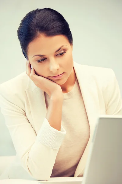 Pensive woman with laptop computer — Stock Photo, Image