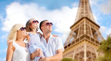 happy family in paris over eiffel tower background clipart