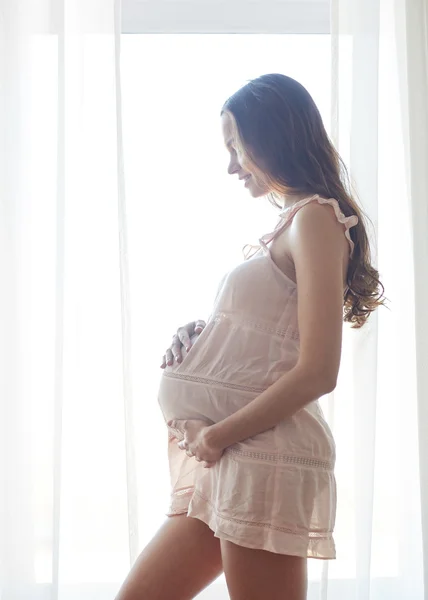 Happy pregnant woman with big bare tummy at home — Stock Photo, Image