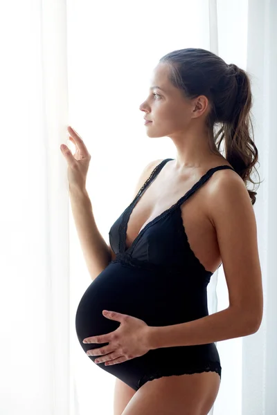 Happy pregnant woman with big bare tummy at home — Stock Photo, Image