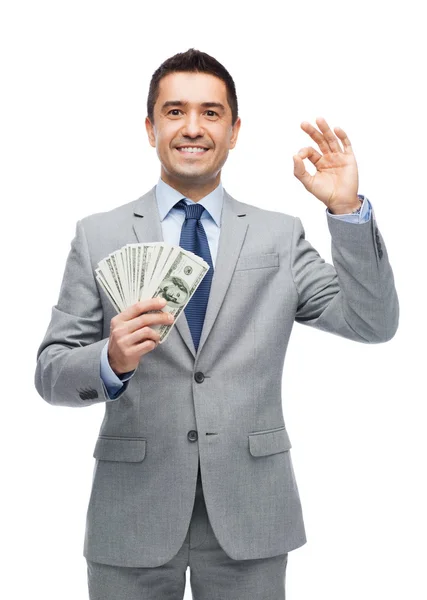 Homem de negócios sorridente com dinheiro do dólar americano — Fotografia de Stock