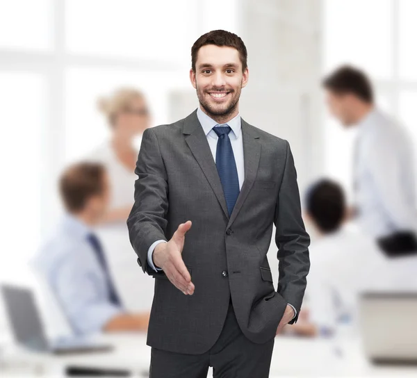 Businessman with open hand ready for handshake — Stock Photo, Image