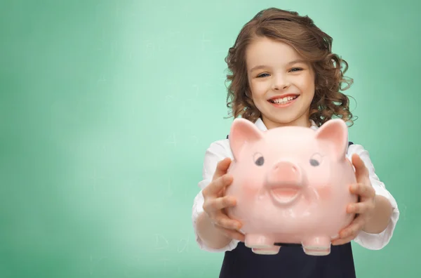 Menina feliz segurando banco porquinho — Fotografia de Stock