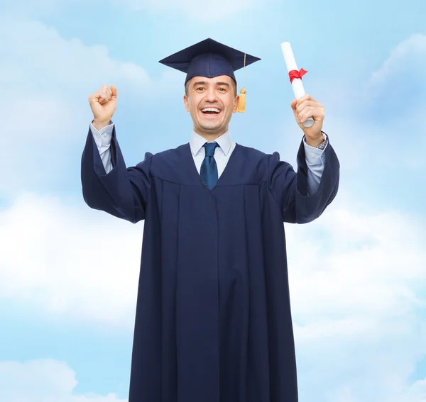 Smiling adult student in mortarboard with diploma — Stock Photo, Image