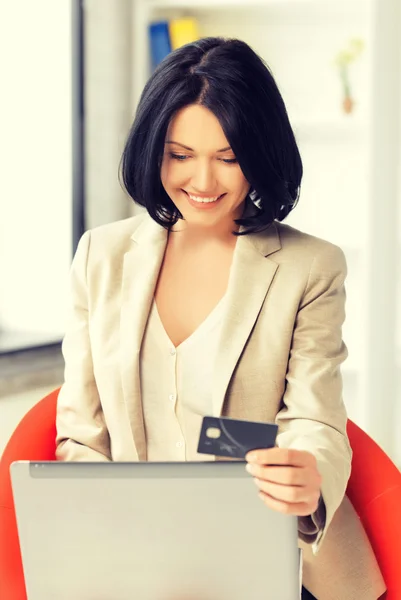 Happy woman with laptop computer and credit card Stock Image
