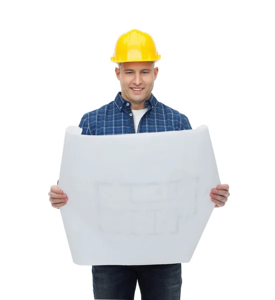 Sorridente construtor masculino no capacete com planta — Fotografia de Stock