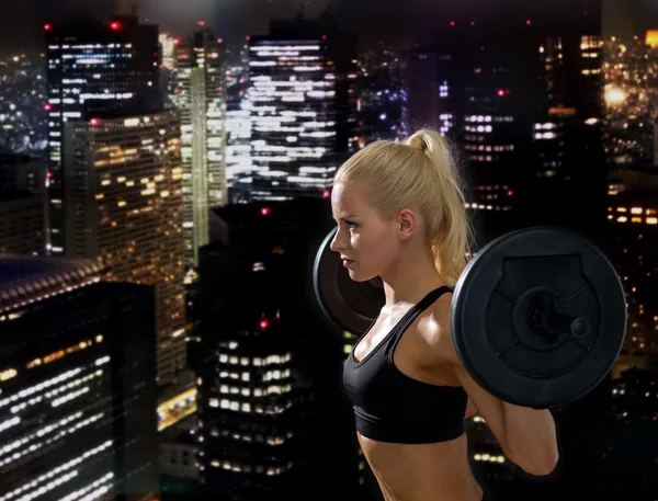 Sporty woman exercising with barbell — Stock Photo, Image