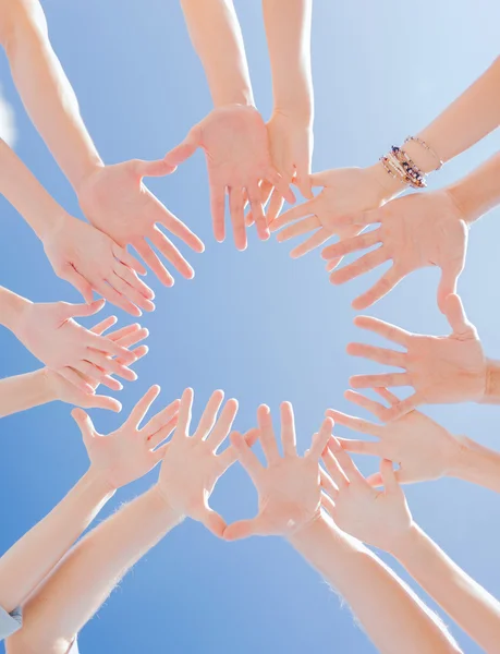 Many hands over blue sky background — Stock Photo, Image
