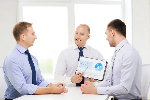 Smiling businessmen with papers in office — Stock Photo, Image