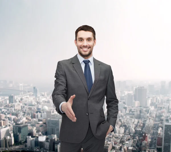 Businessman with open hand ready for handshake — Stock Photo, Image