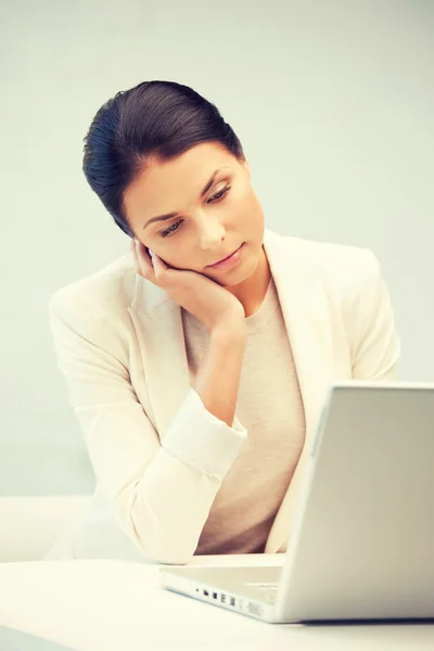 Pensive woman with laptop computer — Stock Photo, Image