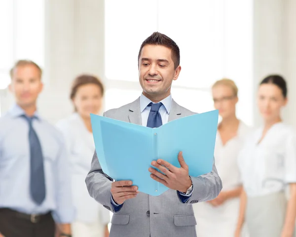 Happy businessman with open folder — Stock Photo, Image