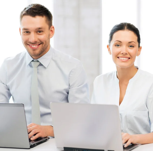 Group of people working with laptops in office — Stock Photo, Image