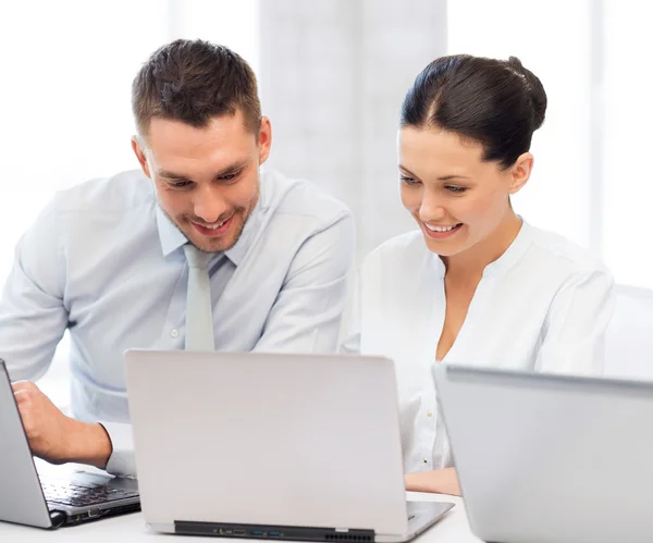 Group of people working with laptops in office — Stock Photo, Image