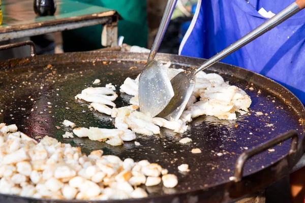 Close up of cook frying meat at street market — Stock Photo, Image