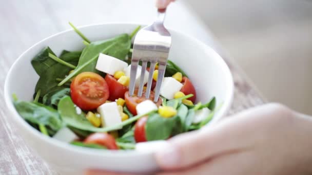 Primer plano de la mujer joven comiendo ensalada en casa — Vídeos de Stock