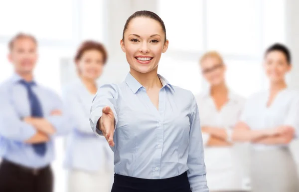 Businesswoman with opened hand ready for handshake — Stock Photo, Image