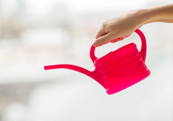 Close up of woman hand holding watering can — Stock Photo, Image