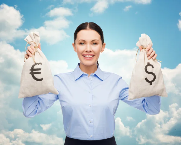 Businesswoman holding money bags with euro — Stock Photo, Image