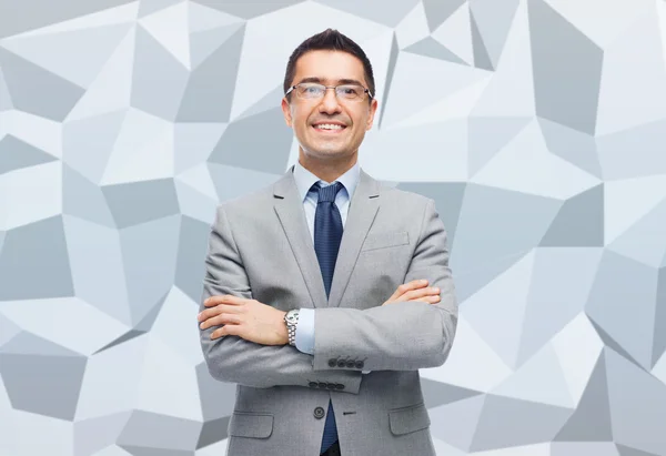 Happy smiling businessman in eyeglasses and suit — Stock Photo, Image