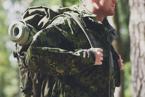 Close up of young soldier with backpack in forest — Stock Photo, Image