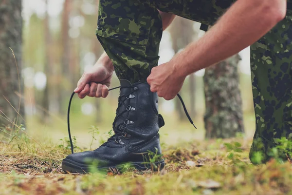 Dekat dengan tentara yang mengikat tali sepatu di hutan — Stok Foto