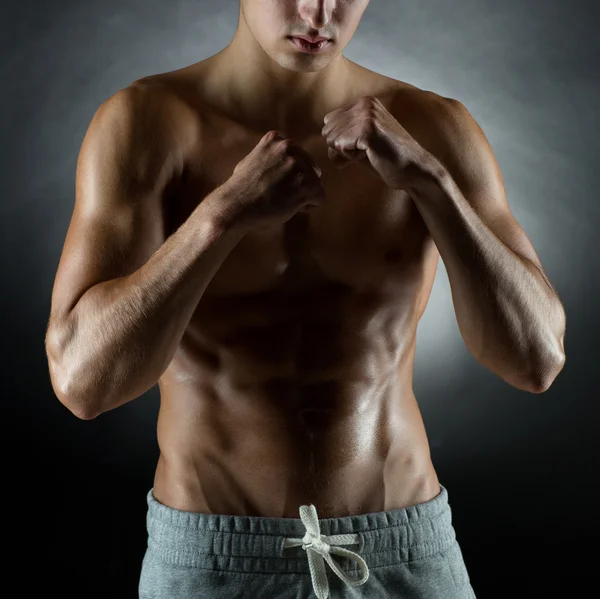 Jeune homme sur le stand de combat sur fond noir — Photo