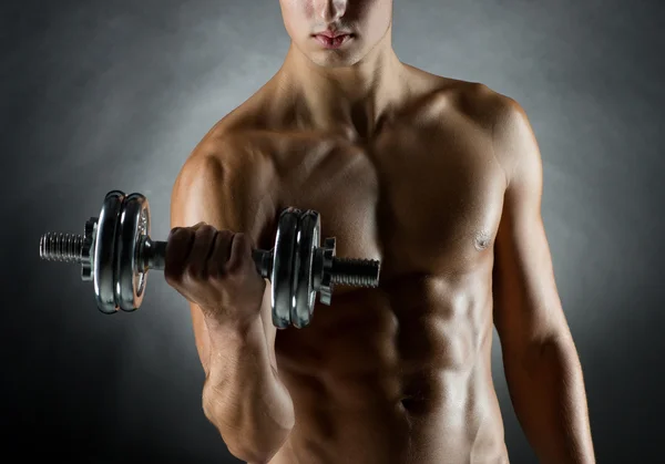 Young man with dumbbell — Stock Photo, Image