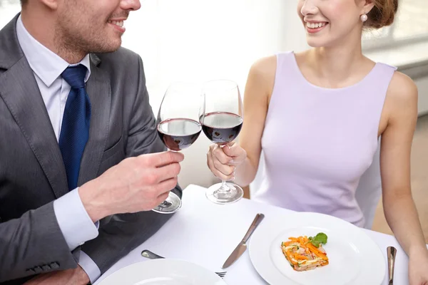 Feliz pareja con copas de vino en el restaurante —  Fotos de Stock