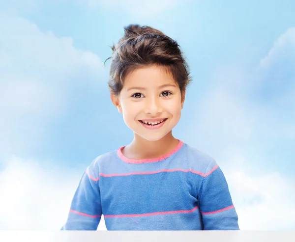 Little girl over blue sky background — Stock Photo, Image