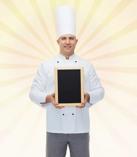 Happy male chef cook holding blank menu board Stock Photo