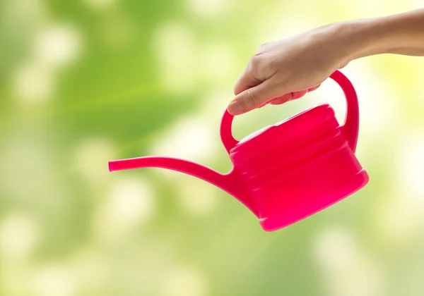 Close up of woman hand holding watering can — Stock Photo, Image