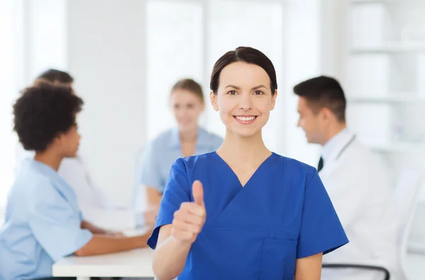 Happy doctor over group of medics at hospital — Stock Photo, Image