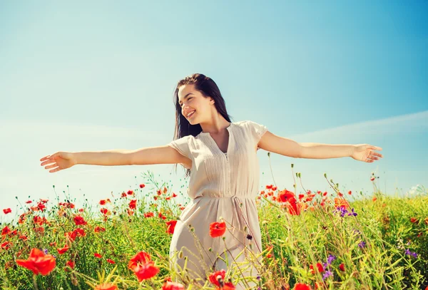 Sorridente giovane donna sul campo di papavero — Foto Stock