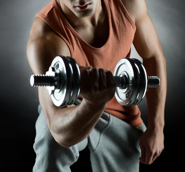 Young man with dumbbell — Stock Photo, Image