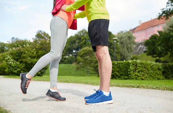 Close up of couple in sportswear outdoors — Stock Photo, Image