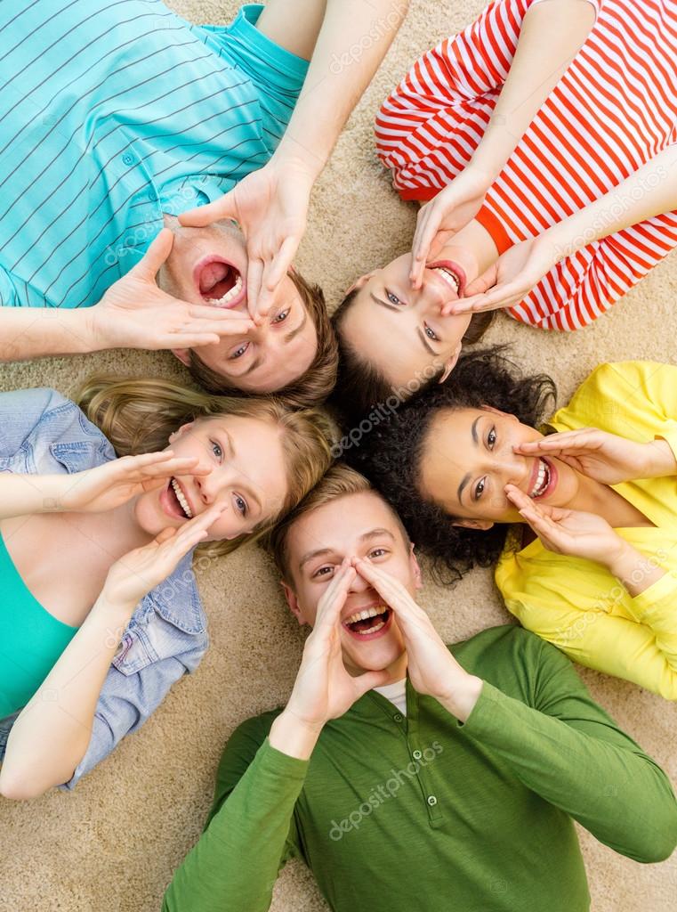 Smiling People Lying Down On Floor And Screaming Stock Photo