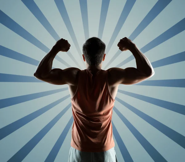 Young man or bodybuilder showing biceps — Stock Photo, Image