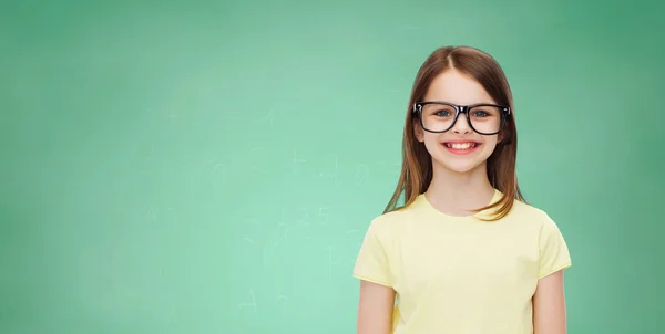 Smiling cute little girl in black eyeglasses — Stock Photo, Image