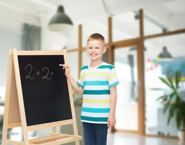 Happy little boy with blackboard and chalk — Stock Photo, Image