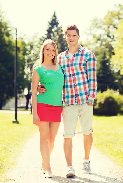 Smiling couple walking in park — Stock Photo, Image