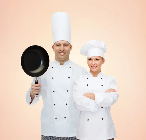 Happy male chef cook holding frying pan Stock Photo by ©Syda