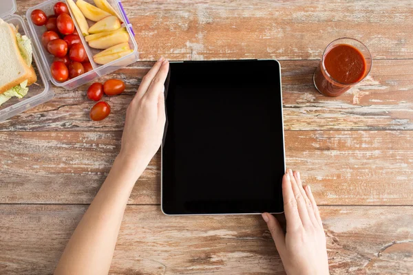 Close up of woman with tablet pc food on table — Stock Photo, Image