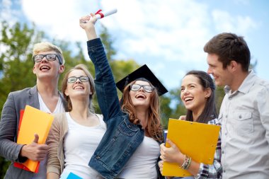 group of smiling students with diploma and folders clipart