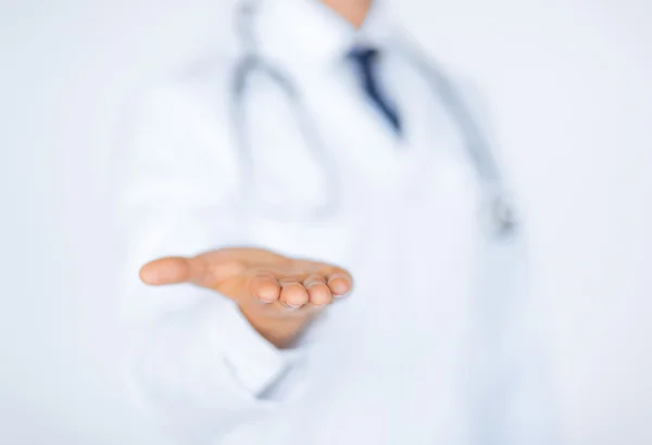 Male doctor holding something in his hand — Stock Photo, Image