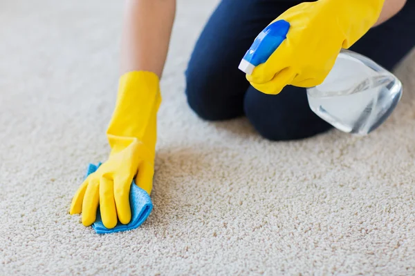 Close up of woman with cloth cleaning carpet — Stock Photo, Image