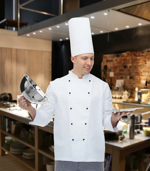 Happy male chef cook opening cloche — Stock Photo, Image